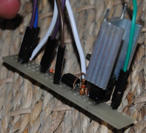 The circuit on a small proto board. The transistor has a big heatsink.